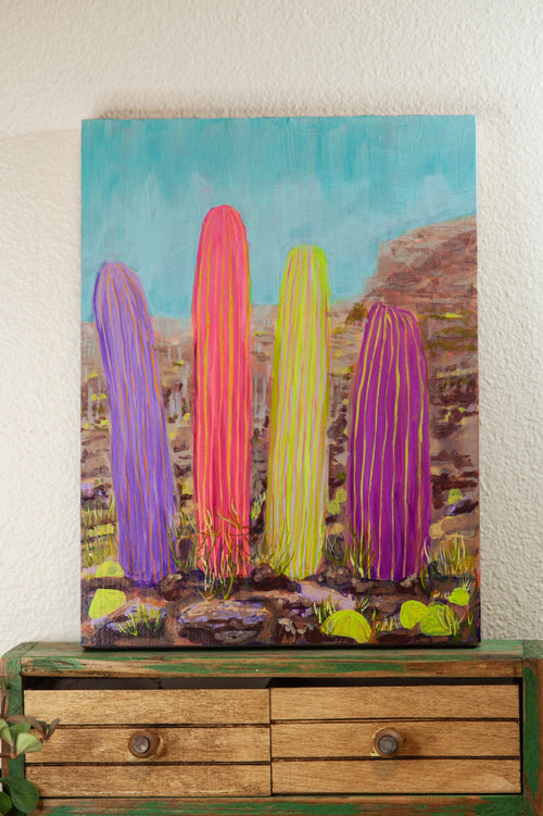 Colorful cactus painting on a wooden dresser against a white wall